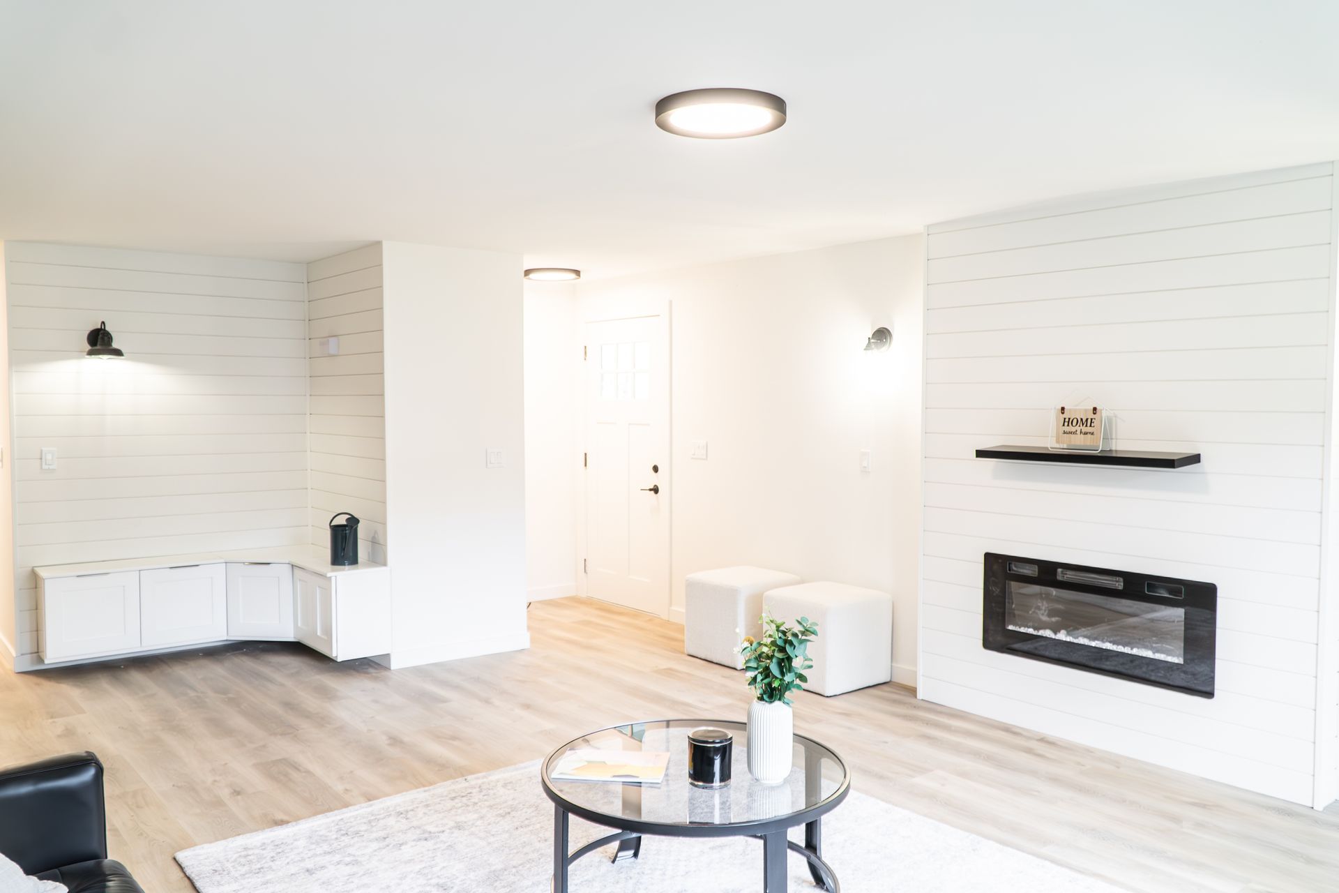 A living room with a fireplace and a round coffee table.