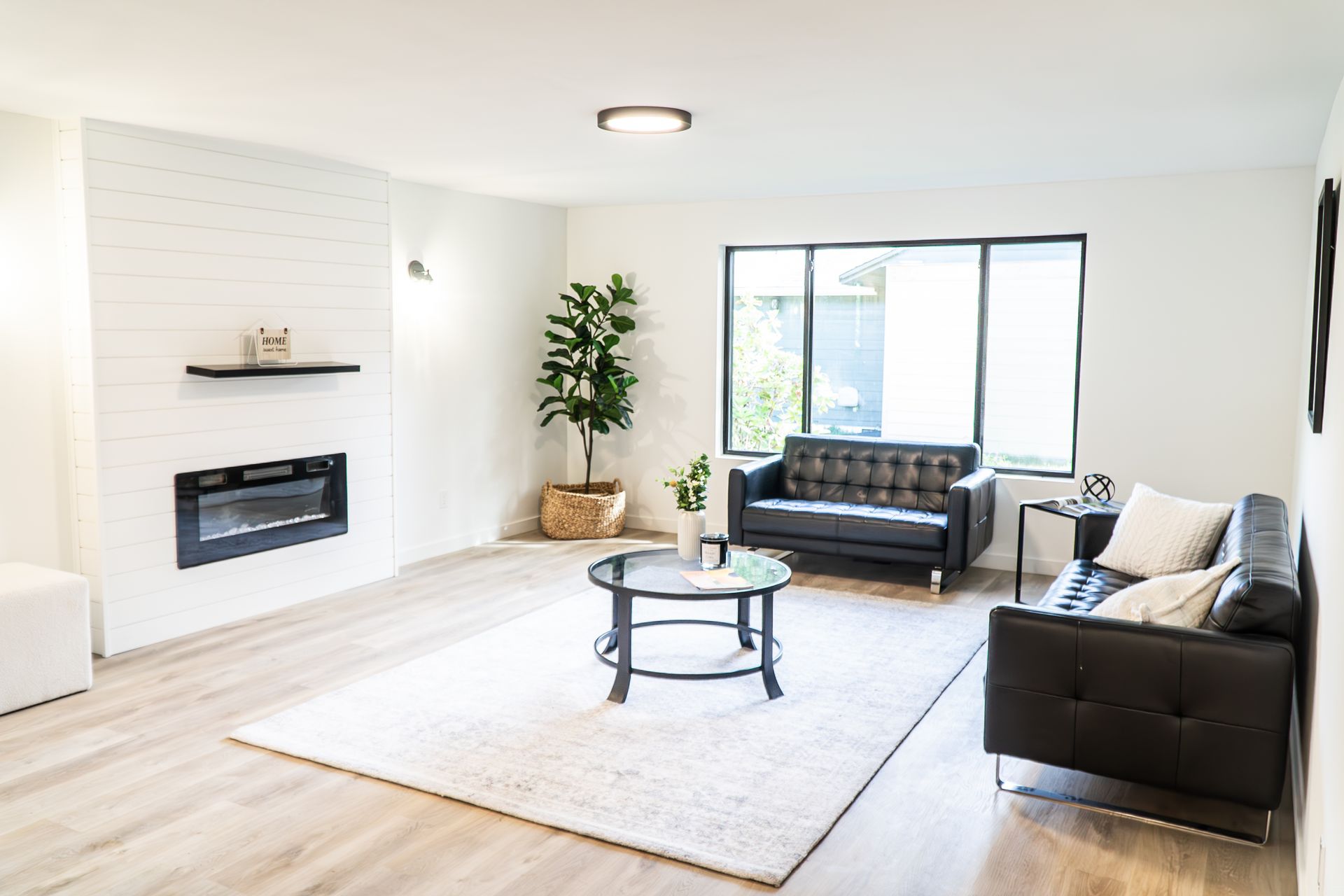 A living room with a couch , coffee table and fireplace.