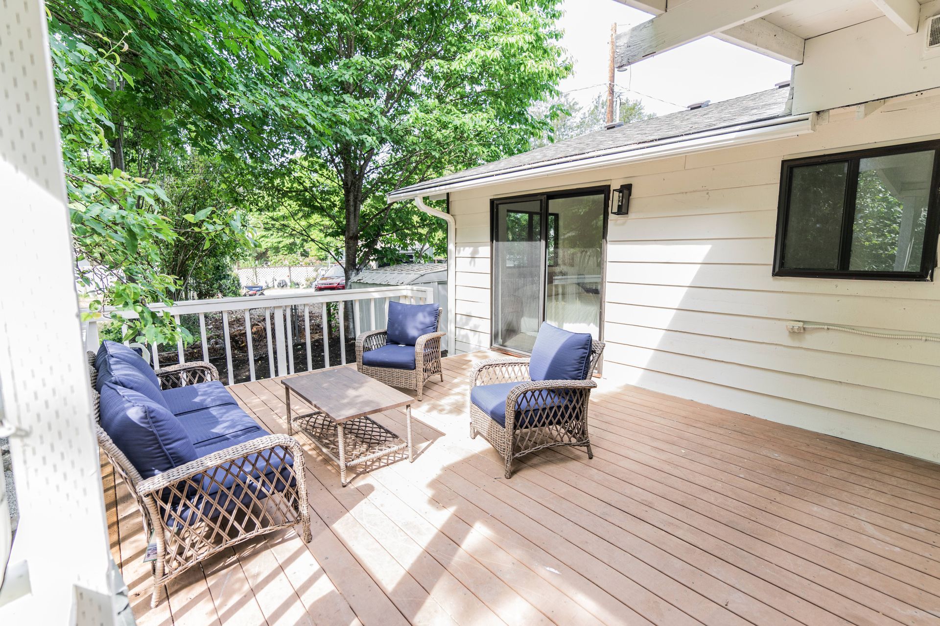 There is a large deck with a lot of furniture on it.