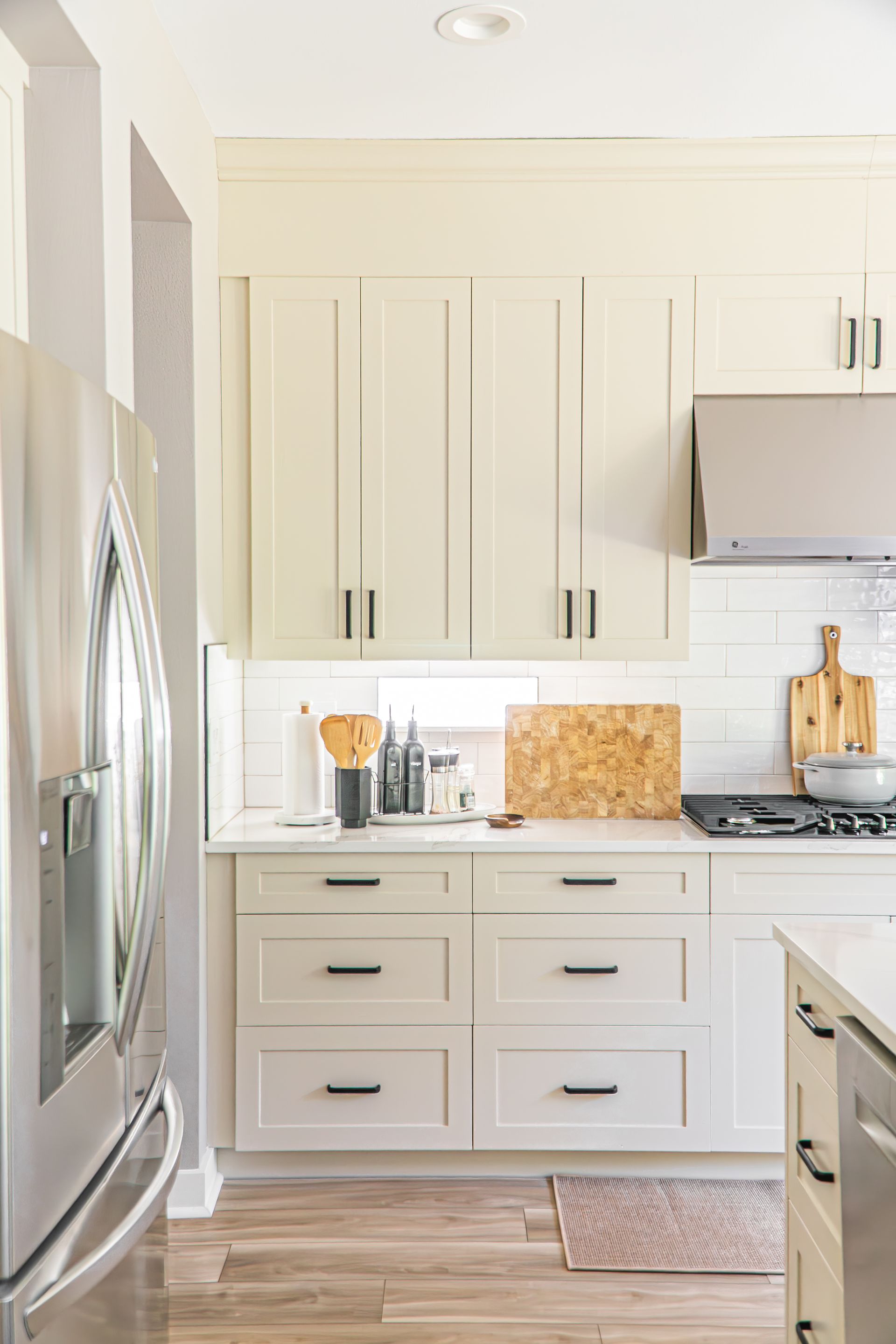 A kitchen with white cabinets and stainless steel appliances.
