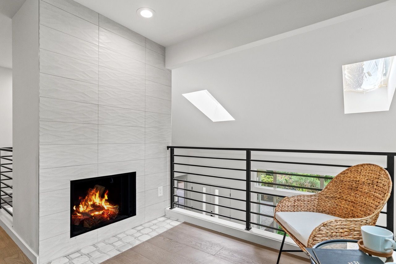 A living room with a fireplace and a chair