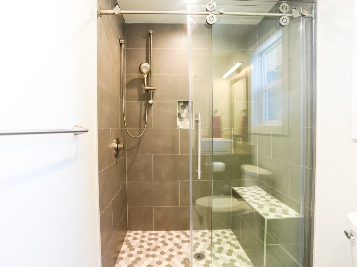 A bathroom with a walk in shower and a toilet.