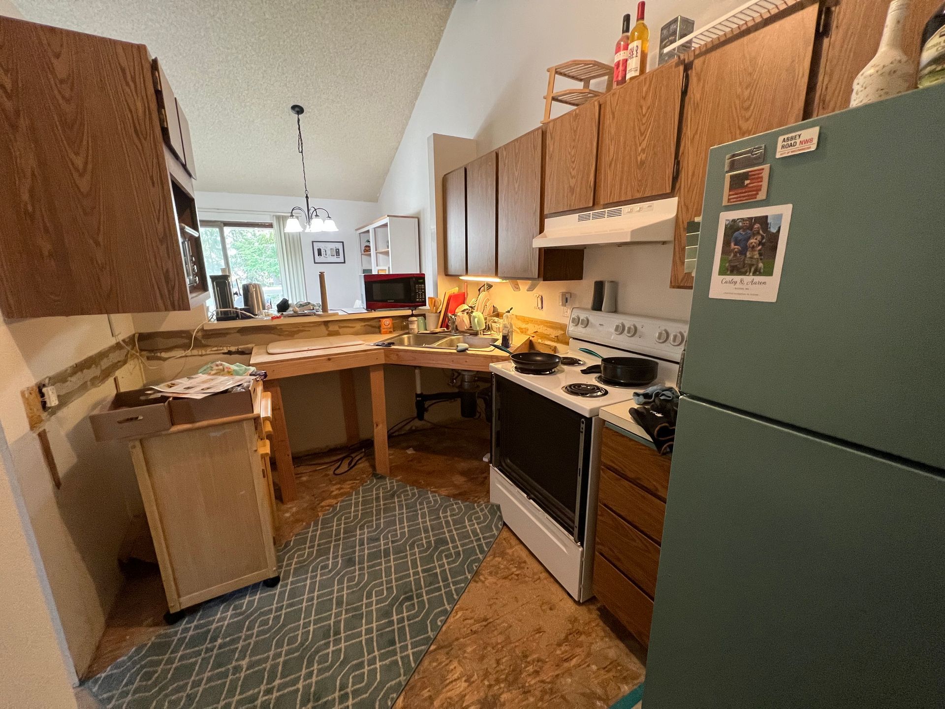 A kitchen with a stove , refrigerator and cabinets