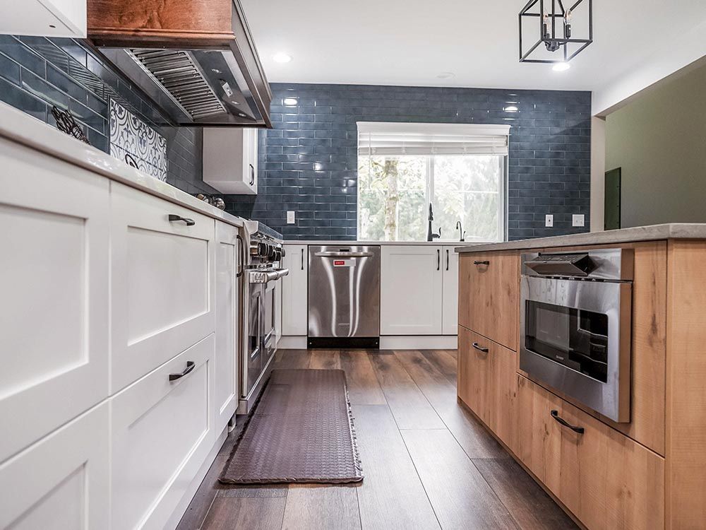 A kitchen with stainless steel appliances and wooden cabinets