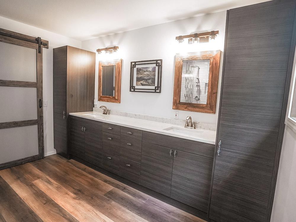 A bathroom with two sinks and two mirrors.