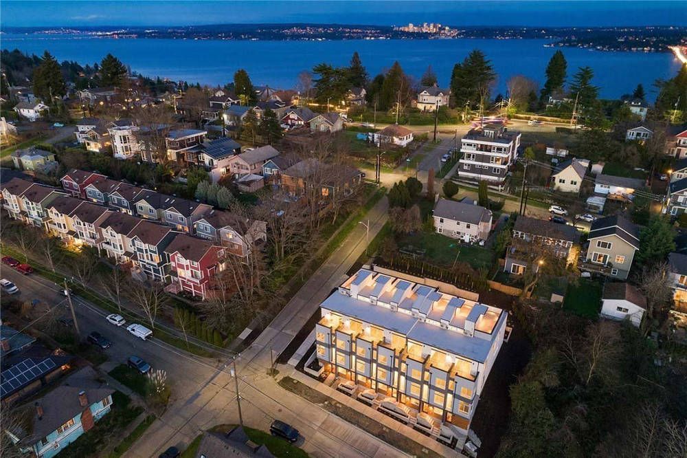 An aerial view of a city with a large building in the middle