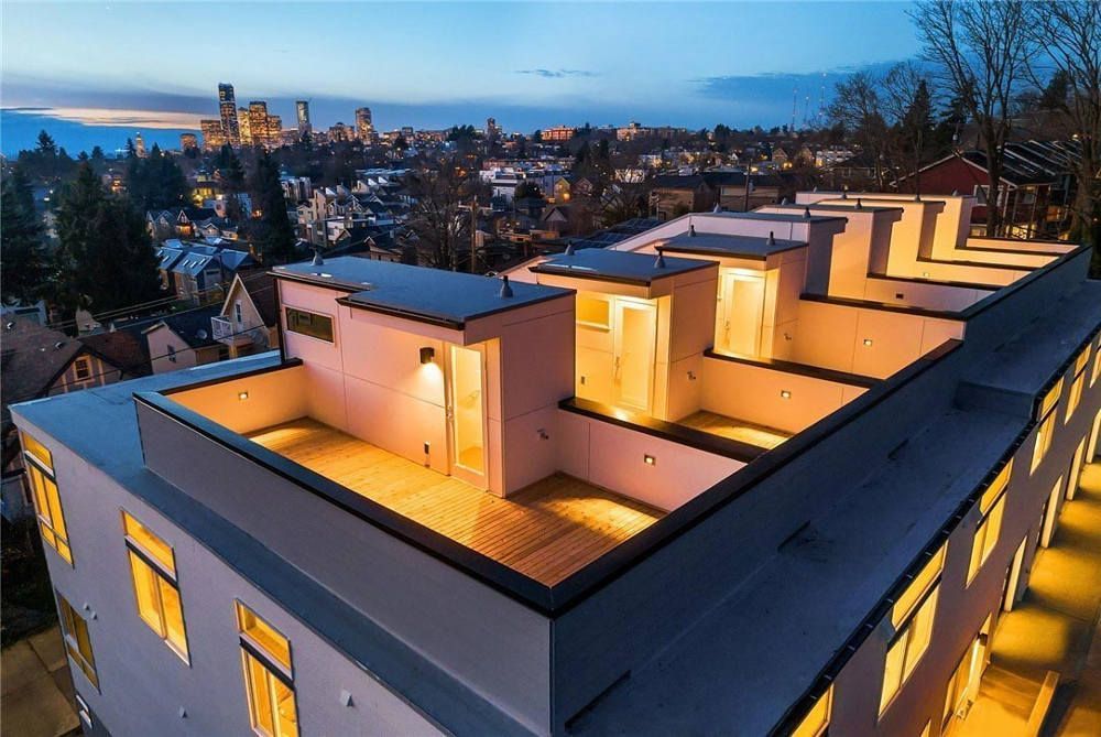 An aerial view of a building with a city in the background