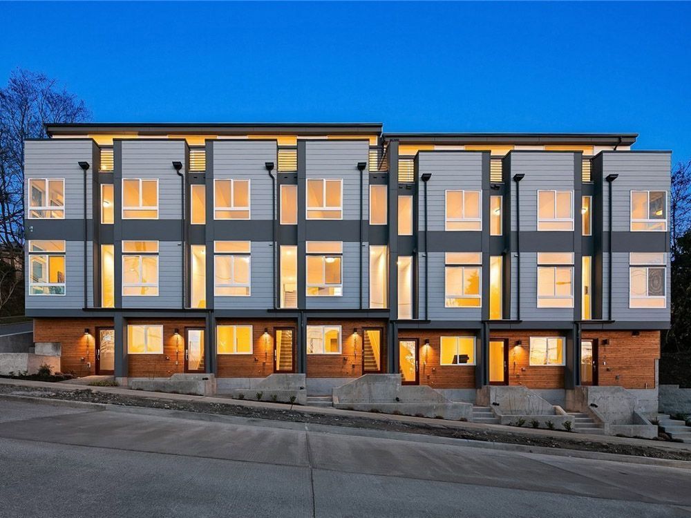 A building with a lot of windows is lit up at night