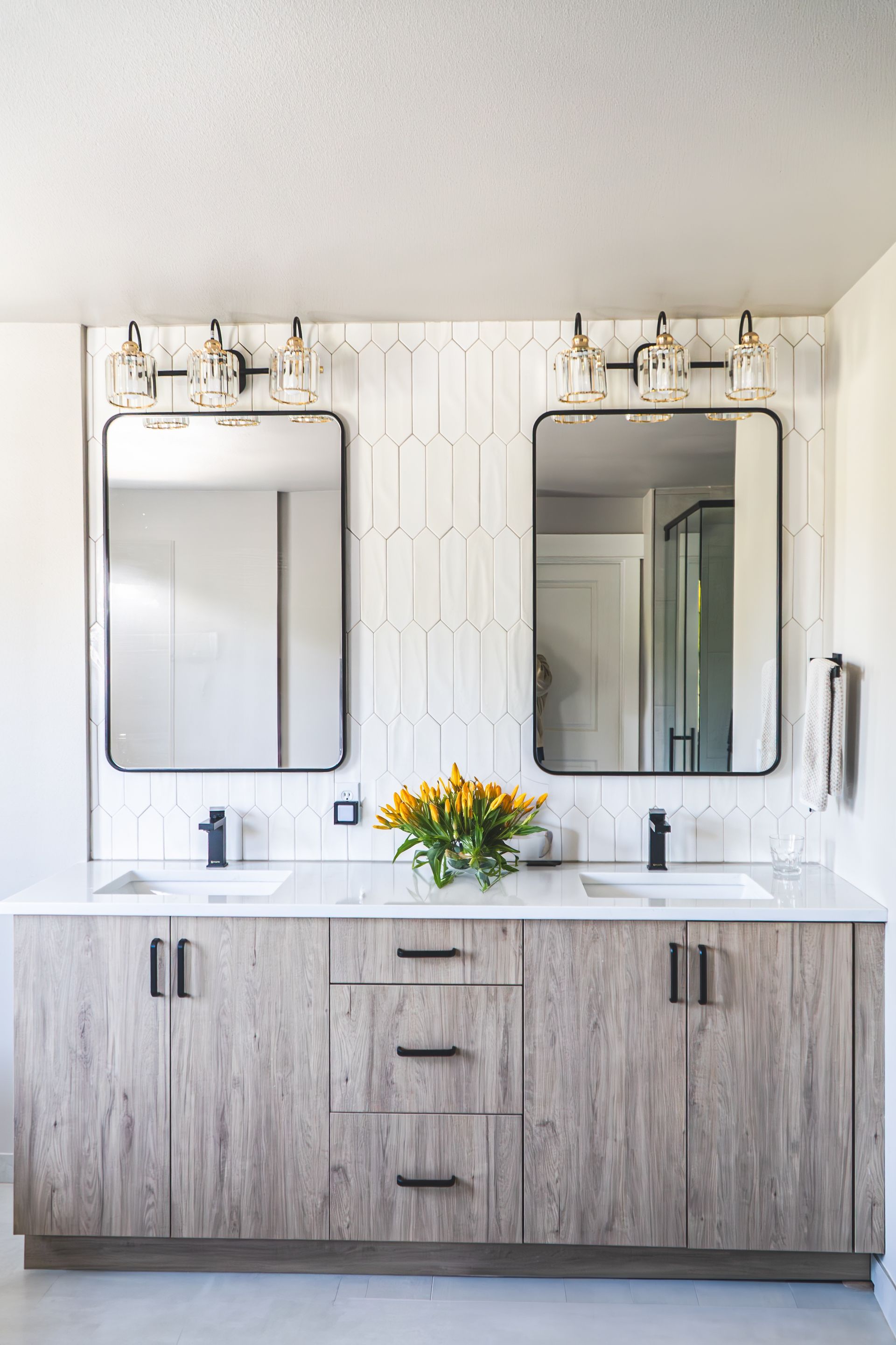 A bathroom with two sinks and two mirrors.