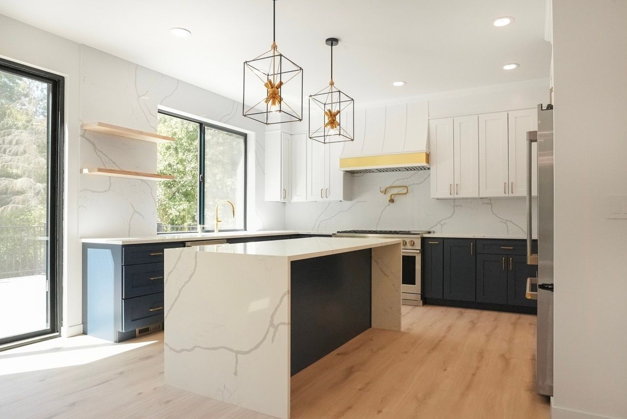 A kitchen with a large island and stainless steel appliances