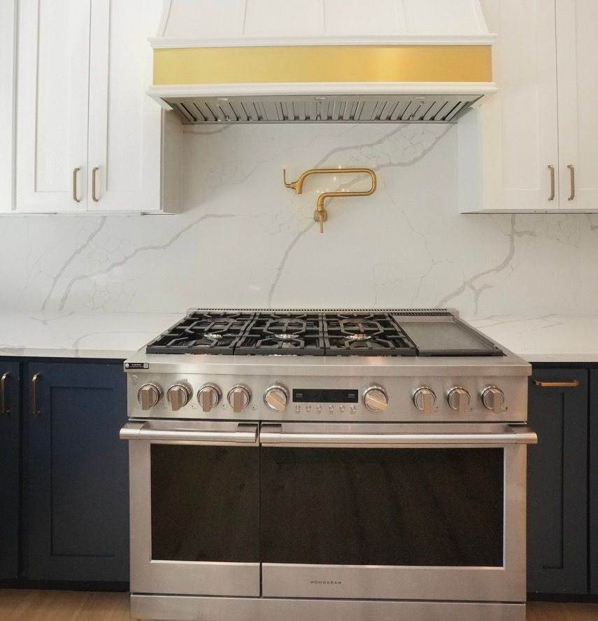 A stove with a gold hood is in a kitchen
