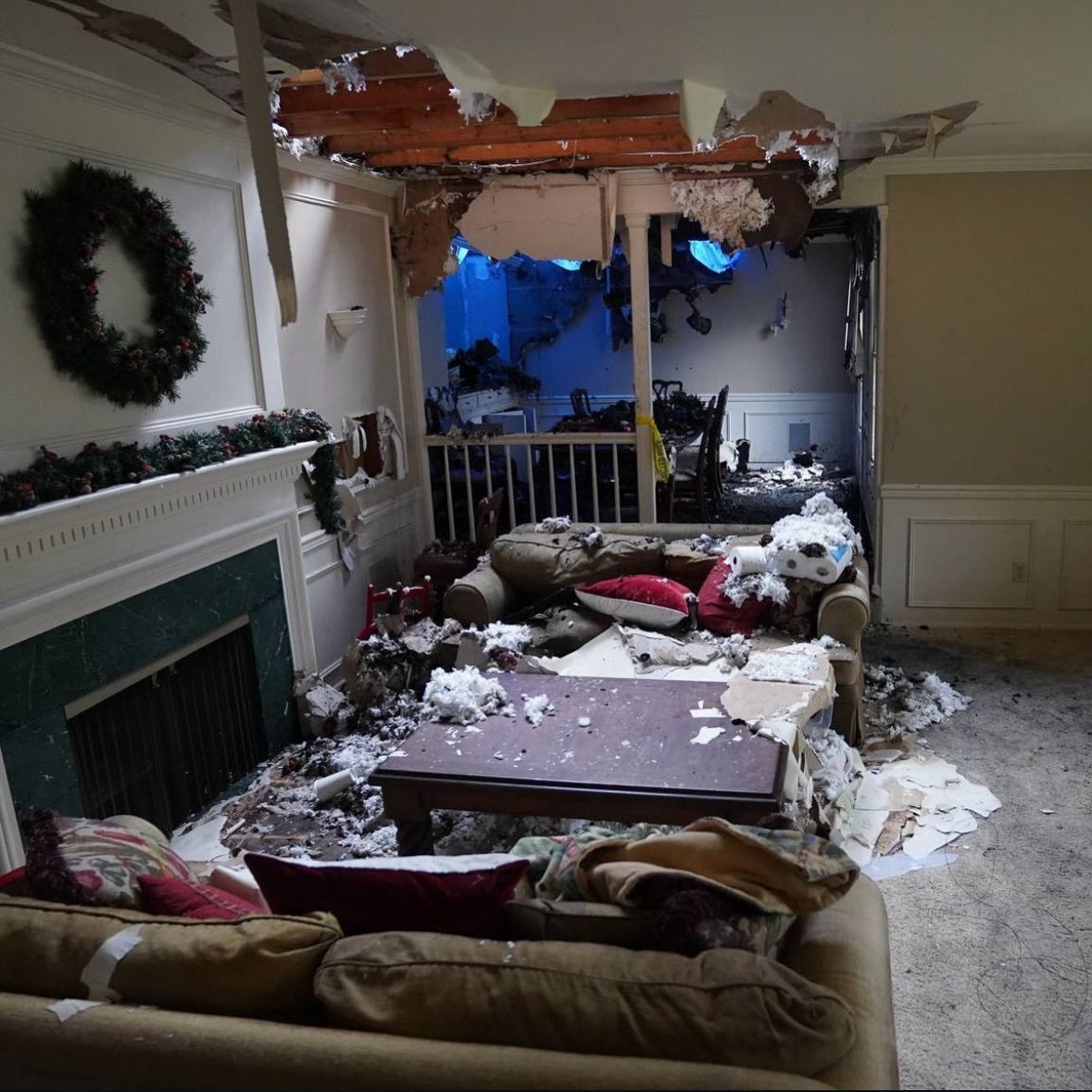 A living room with a couch a table and a fireplace