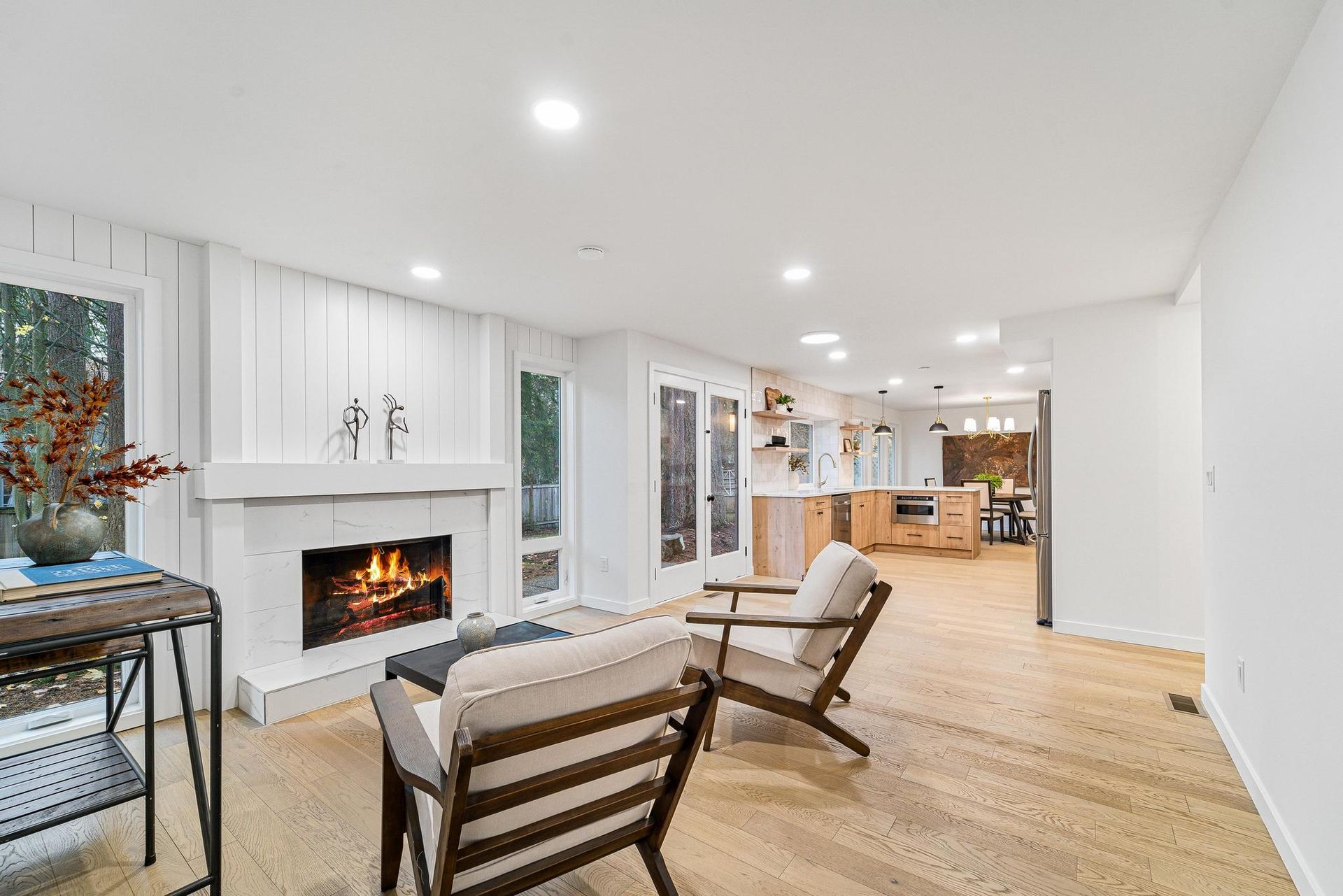 A living room with a fireplace , chairs , and a table.