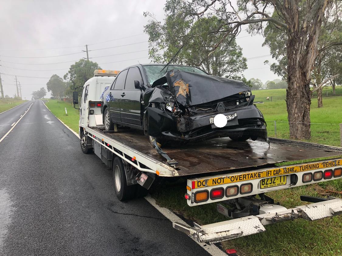 Truck Towing Black Car — Roadside Assist Central Coast in Newcastle, NSW
