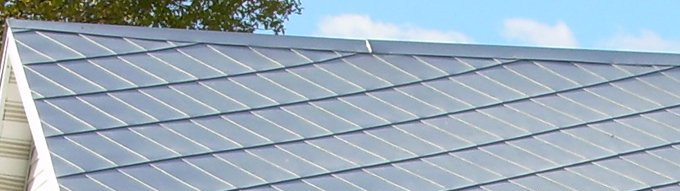 Un gros plan d'un toit avec un ciel bleu en arrière-plan.