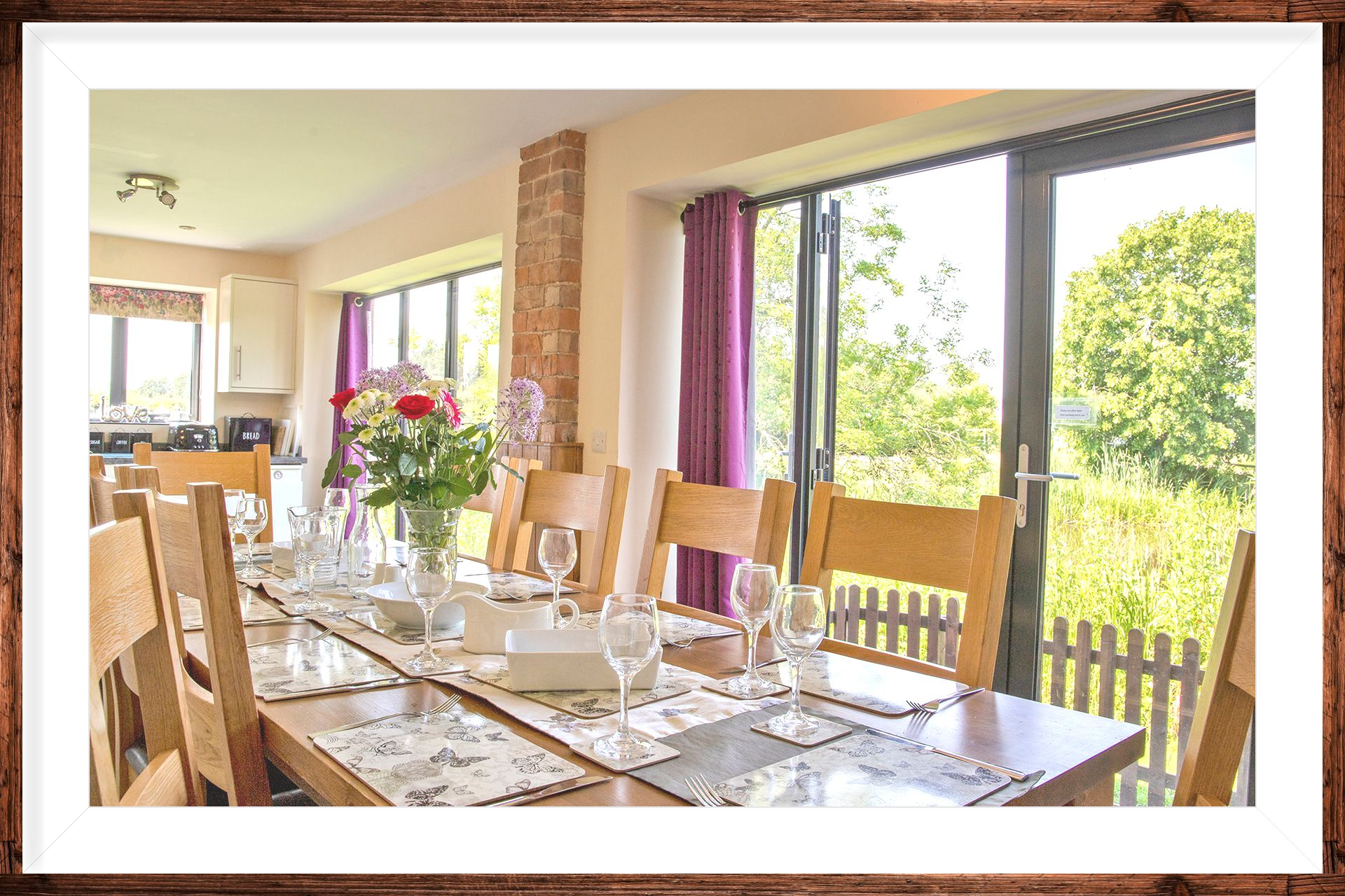 A laid Dining table in a holiday cottage, with countryside views
