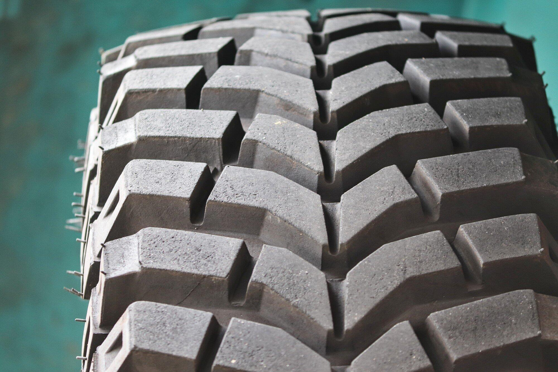 Close-up of a rugged off-road tire tread with large deep grooves