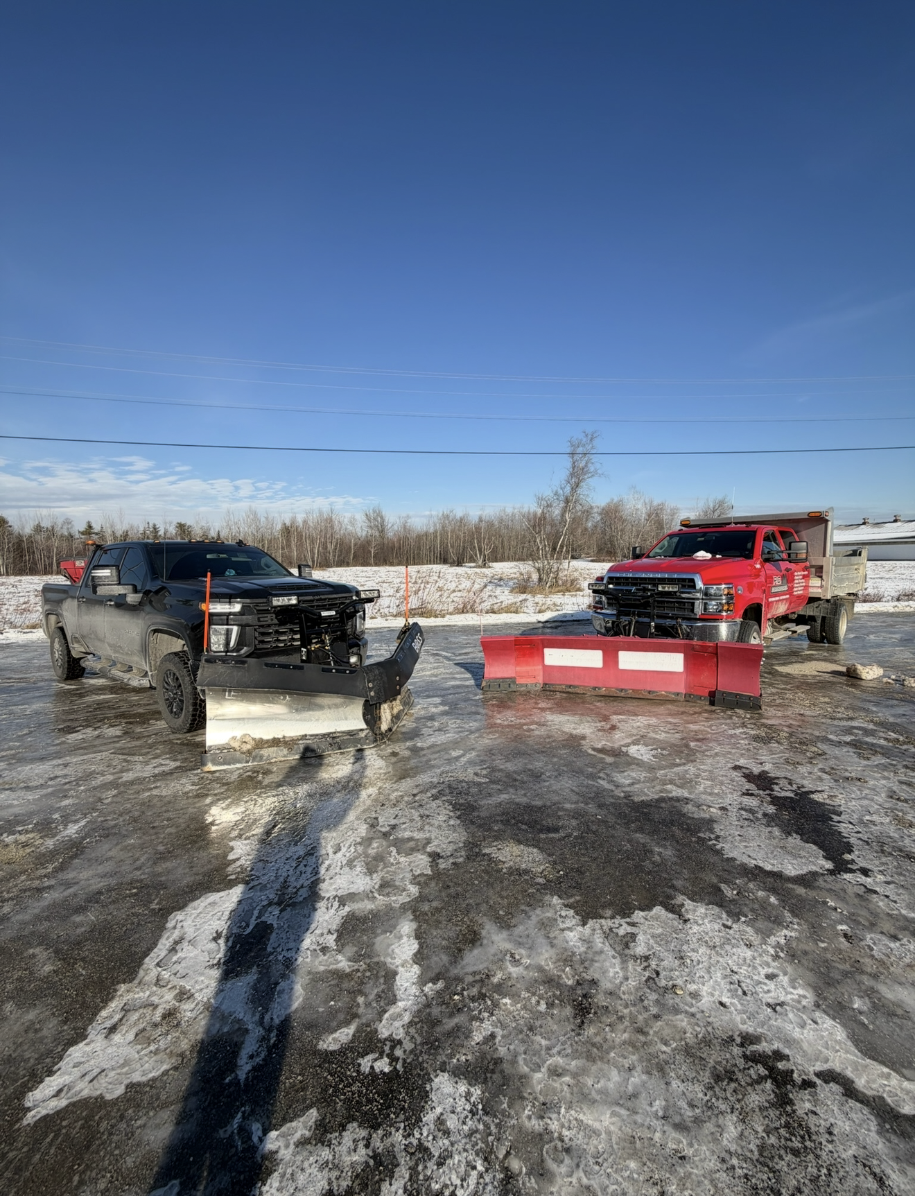 A person is shoveling snow with a red shovel.