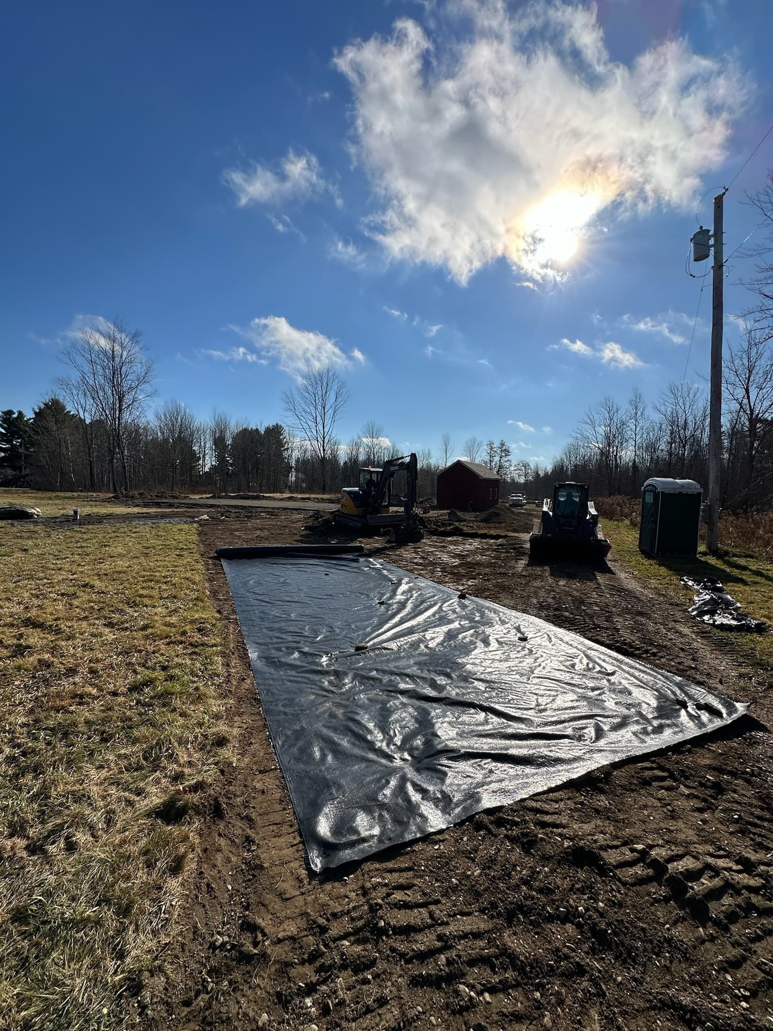 A large piece of plastic is sitting in the middle of a field.
