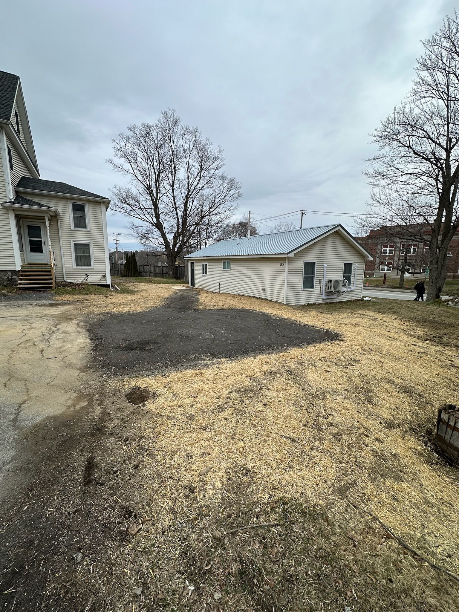 A couple of houses are sitting next to each other in a field.