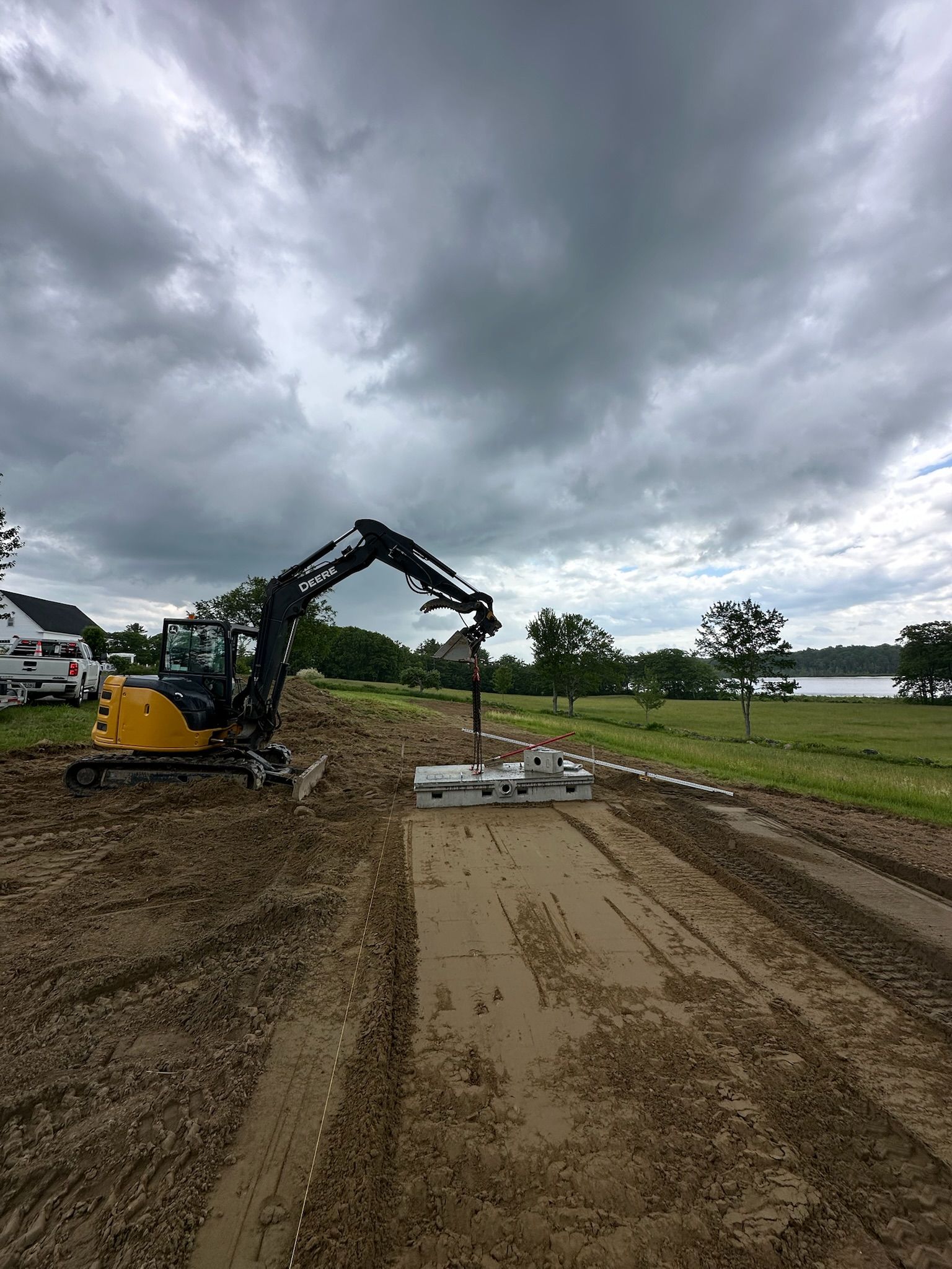 A bulldozer is cutting down trees in a field.
