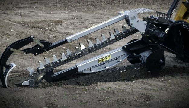 A machine is sitting on top of a dirt field.