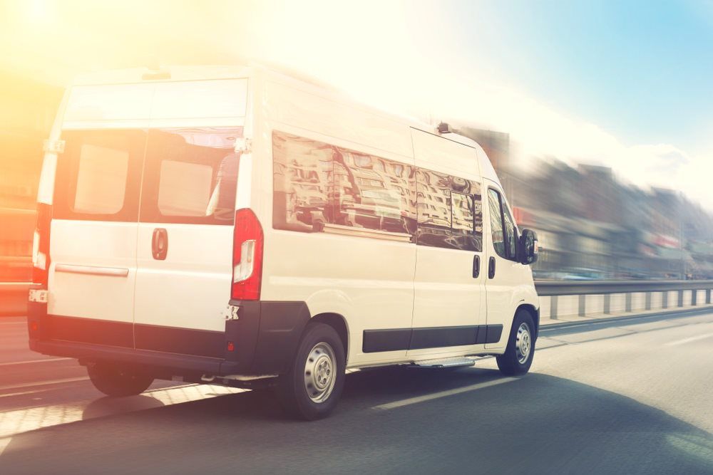 Male Driver Standing In Front Of Bus — Shuttle Buses from Hervey Bay in Dundowran Beach, QLD