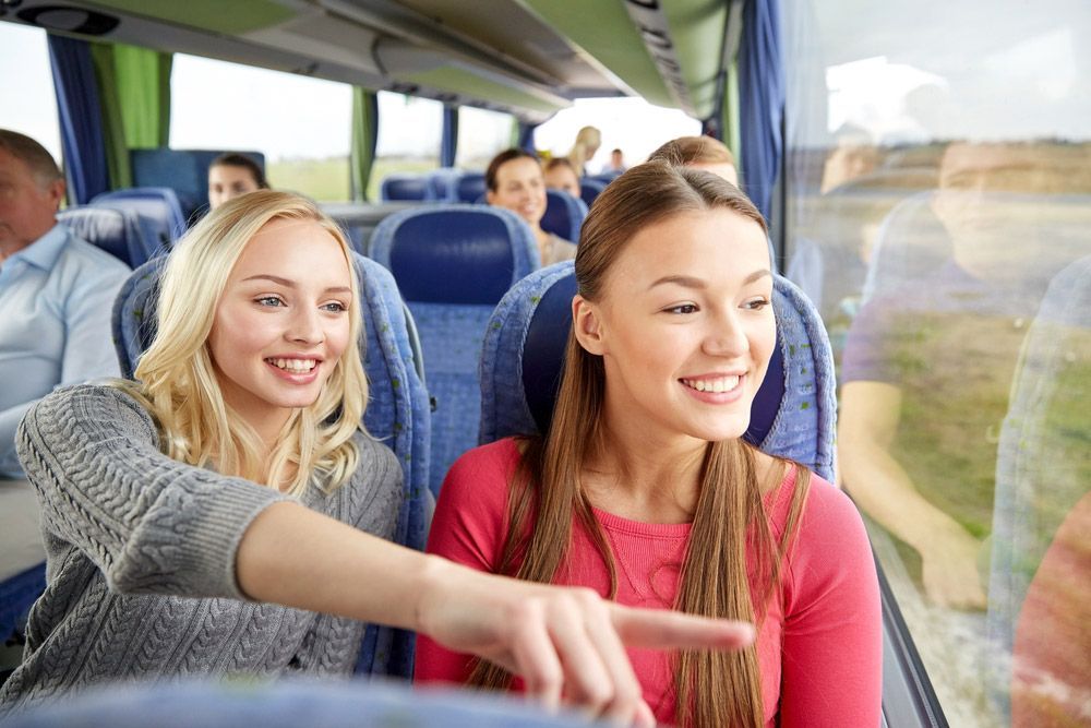 Young Women Or Teenage Friends Riding In Shuttle Bus — Shuttle Buses from Hervey Bay in Dundowran Beach, QLD