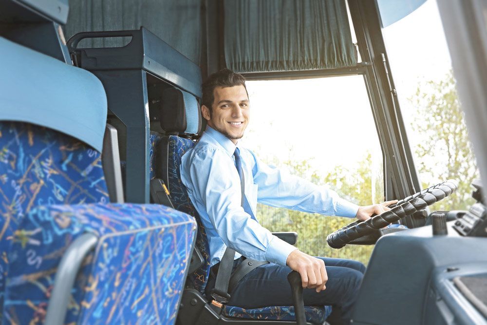 A Man Driver Sitting In Shuttle Bus — Shuttle Buses from Hervey Bay in Dundowran Beach, QLD