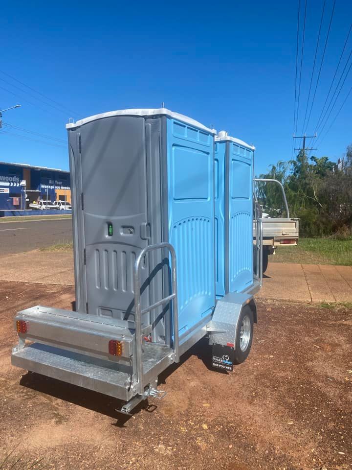 A Blue Portable Toilet is Sitting on Top of a Trailer — Ecotreat Solutions NT in Palmerston, NT