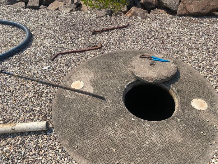 A Manhole Cover With a Hole in the Middle of It — Ecotreat Solutions NT in Katherine, NT