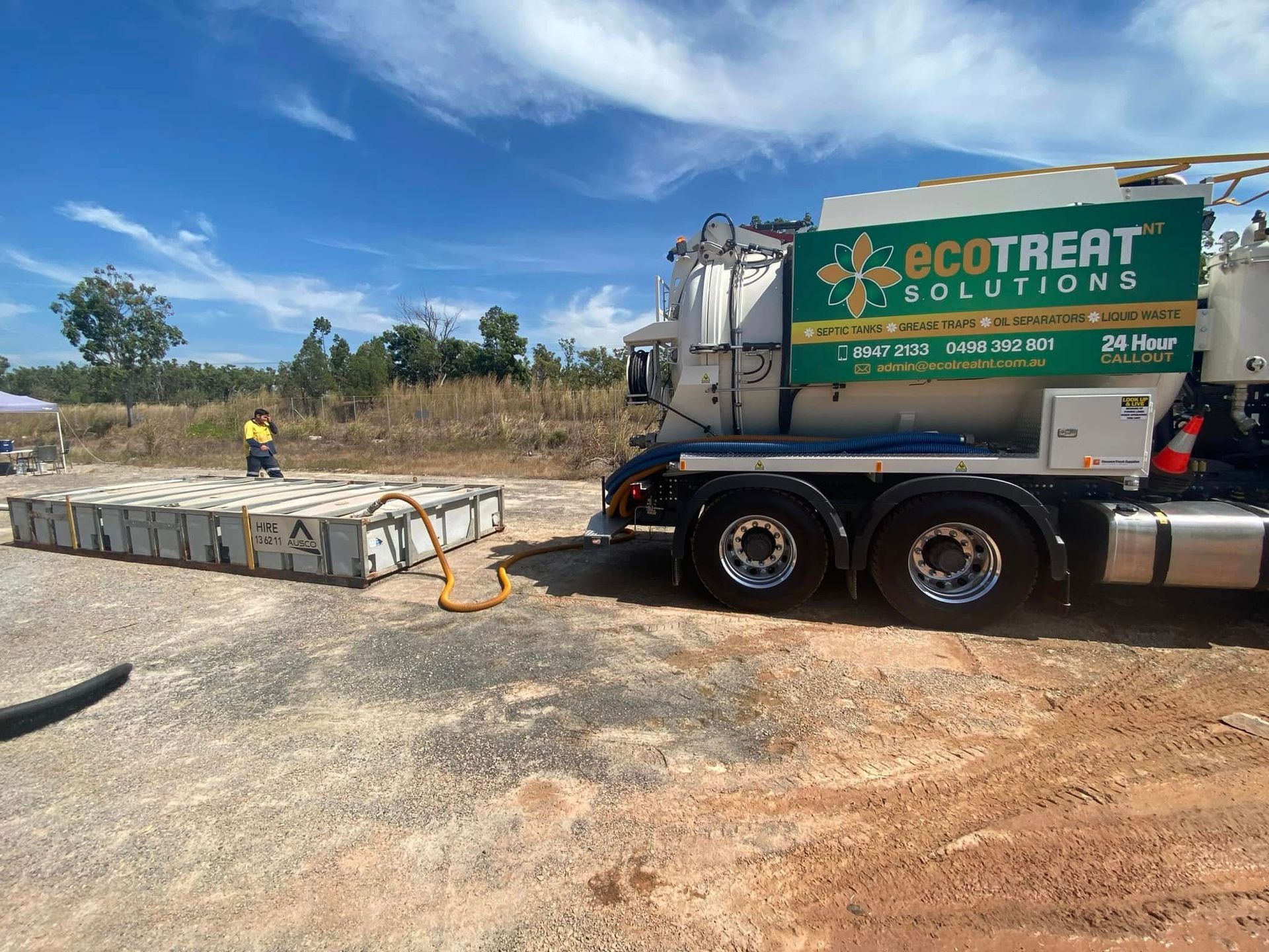 A truck is pumping a hose on a dirt field — Ecotreat Solutions NT in Berrimah, NT
