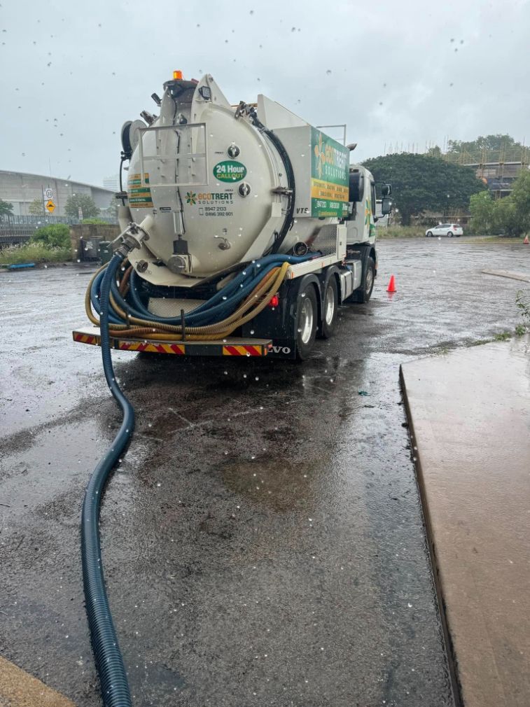 A Vacuum Truck is Parked in a Parking Lot on a Rainy Day — Ecotreat Solutions NT in Winnellie, NT