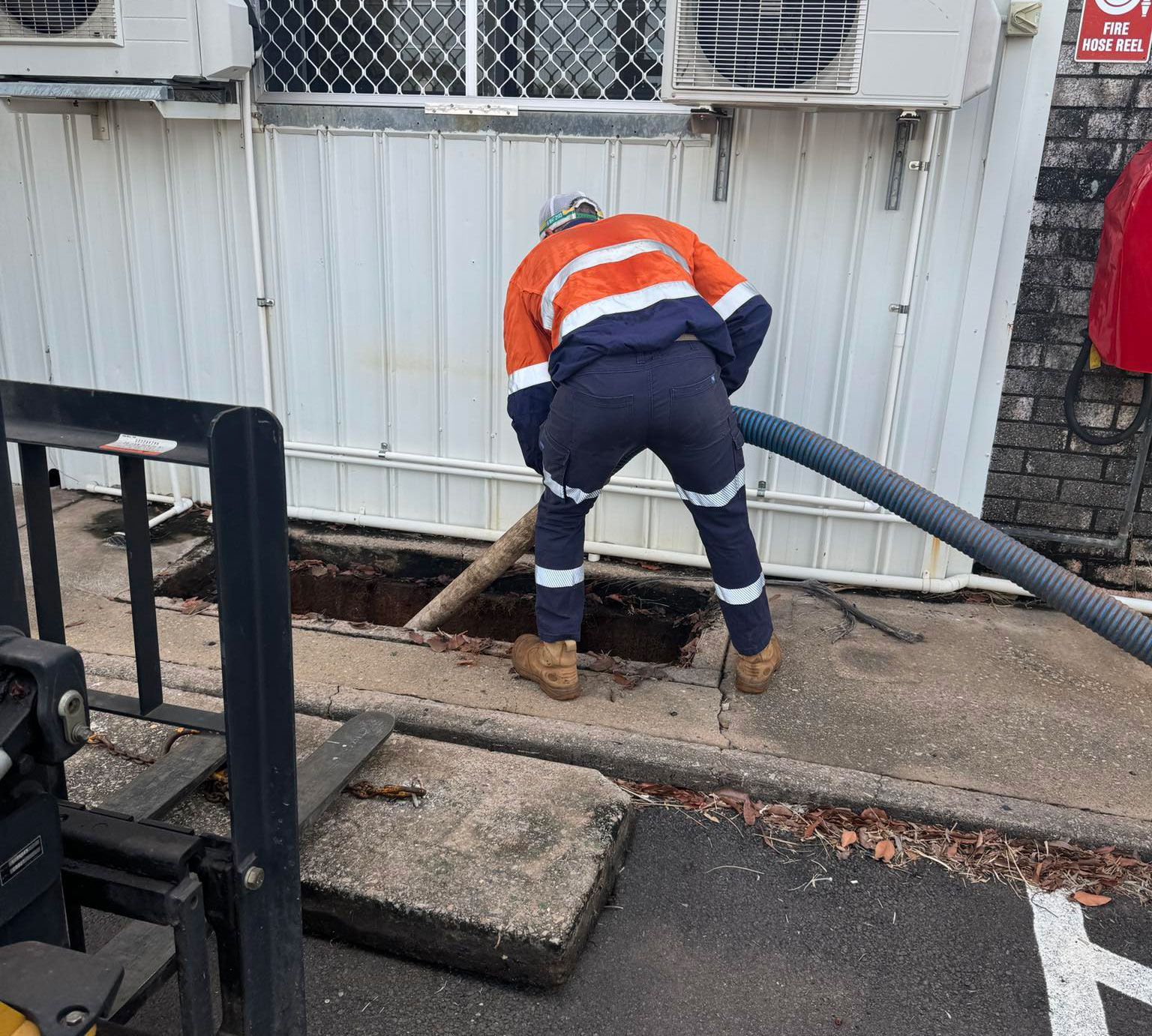 Man Cleaning A Grease Trap In Darwin