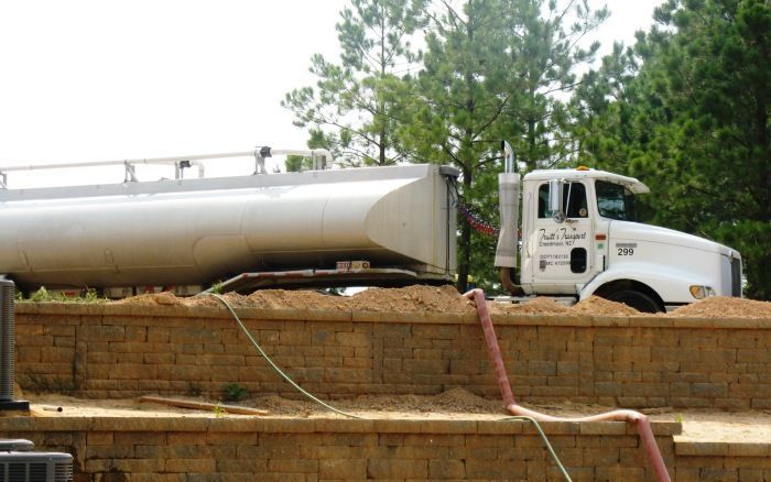 White tanker truck delivering clean water to targeted areas on location.