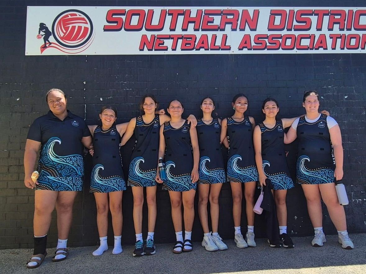 Netball team posing in front of 