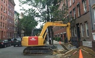 Backhoe De-water Excavating in the Street — Oil tank services in Paterson, NJ