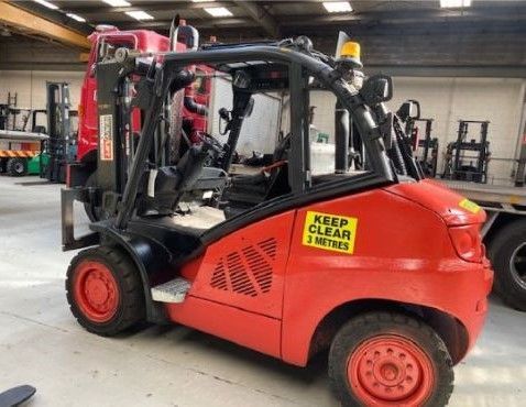 A red forklift with a keep clear sticker on it at Heavy Lift Forklifts Melbourne's warehouse