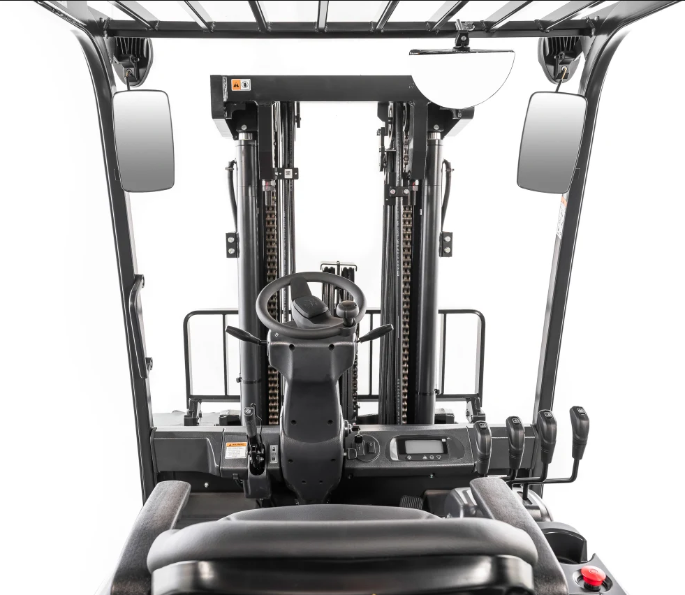 Forklift cab interior, featuring a steering wheel, control levers, and gauges.