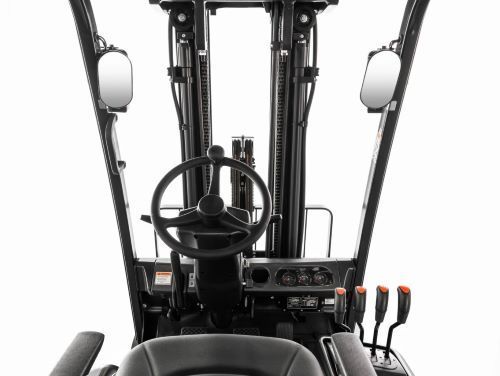 Forklift interior: black dashboard, steering wheel, controls, side mirrors, and seat.