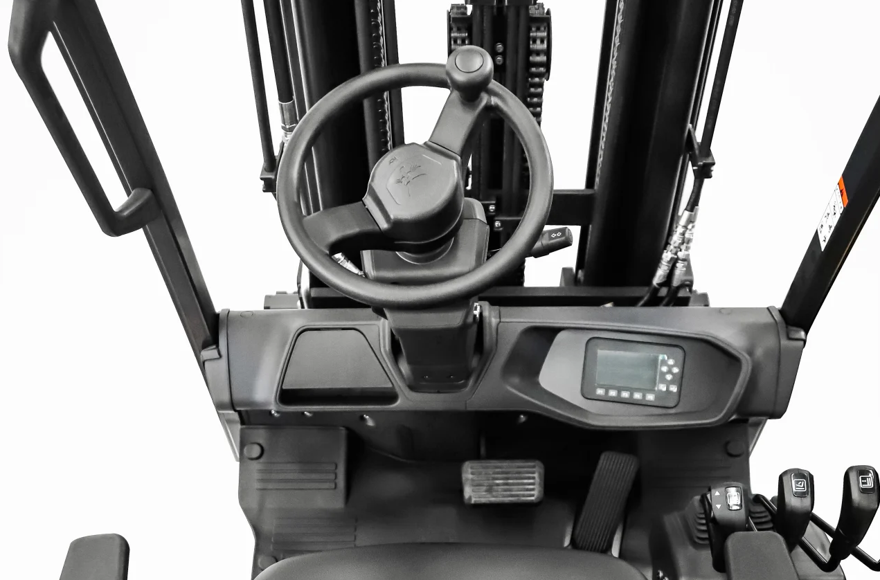 Forklift interior showing steering wheel, digital display, and control levers.