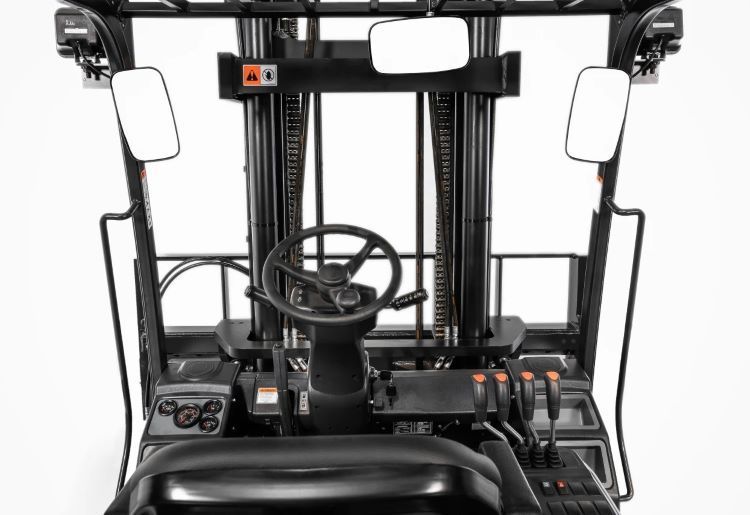 Interior of a black forklift, with steering wheel, controls, and side mirrors.