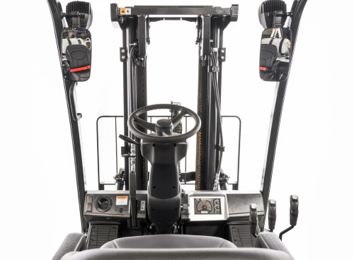Forklift cab interior; steering wheel, control panel, protective overhead guard.