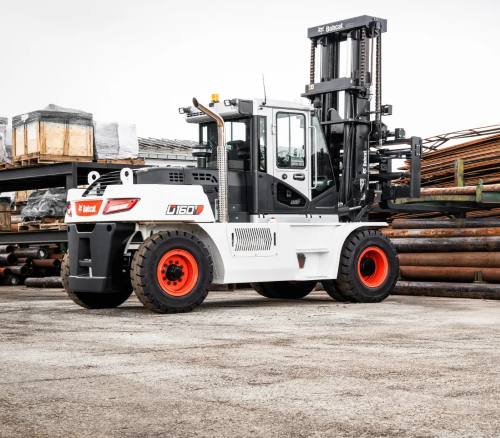 White Bobcat forklift with orange wheels on a concrete surface, next to a stack of metal pipes.
