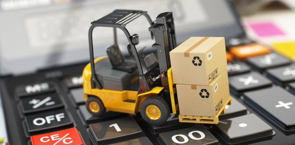 Representation of forklift cost - yellow forklift with cardboard boxes on a calculator