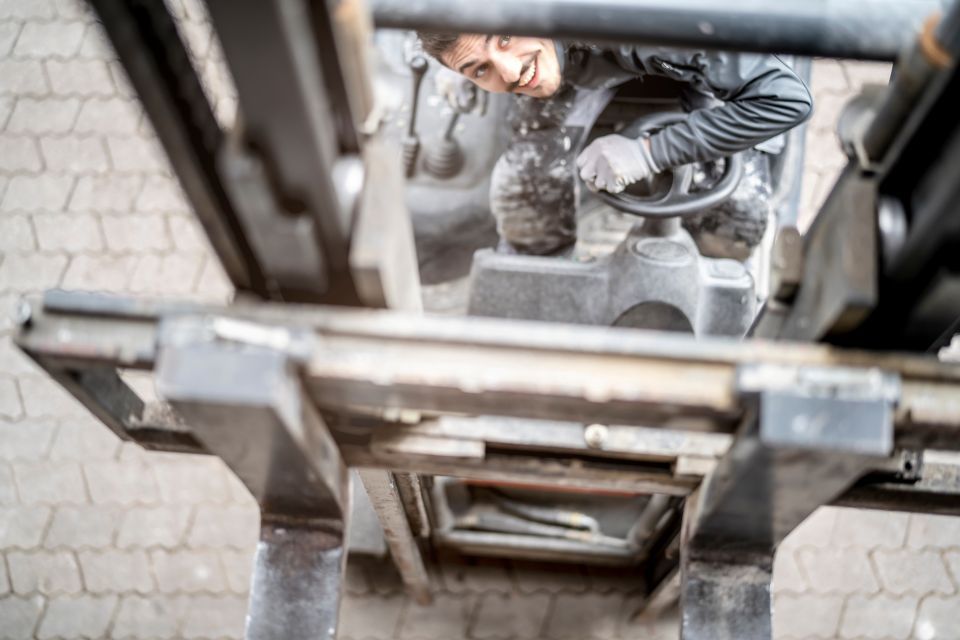 forklift mast: man operating forklift, smiling, looking up