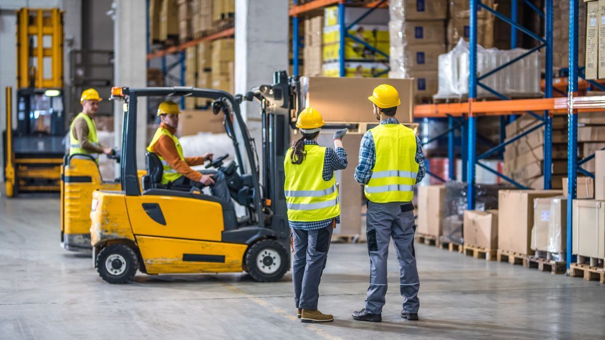 people discussing how to improve forklift safety in a warehouse