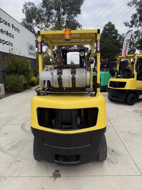 A bobcat forklift is parked in a parking lot