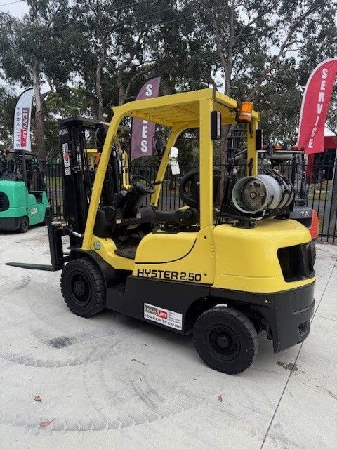 A yellow hyster forklift for sale is parked in a parking lot