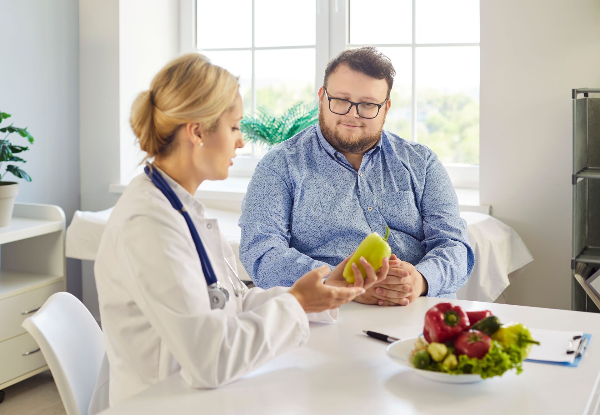 Weight loss management consultation with a healthcare provider discussing healthy nutrition. Weight loss management consultation with a healthcare provider discussing healthy nutrition.